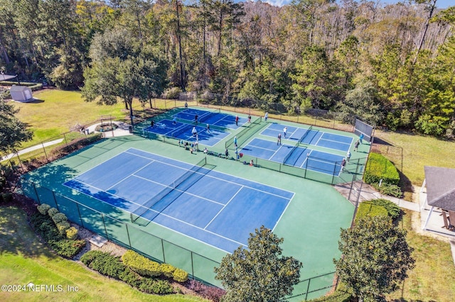 view of tennis court with a lawn