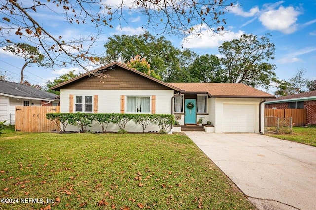 ranch-style home featuring a garage and a front yard