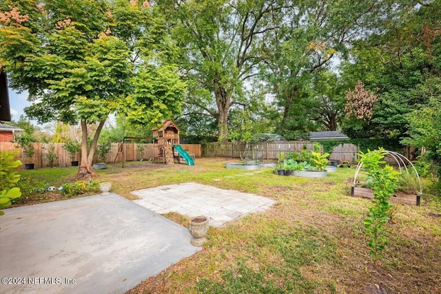 view of yard featuring a patio area and a playground