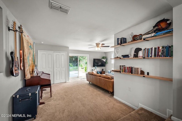 living room with ceiling fan and light colored carpet