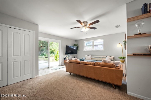 carpeted living room with plenty of natural light and ceiling fan