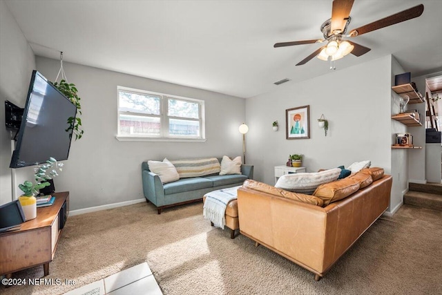 carpeted living room with ceiling fan