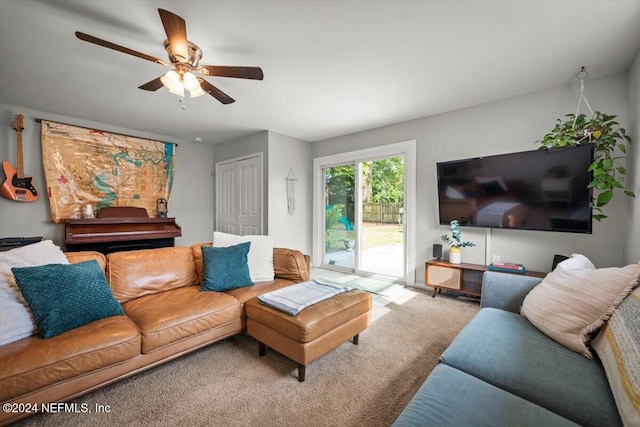 carpeted living room featuring ceiling fan