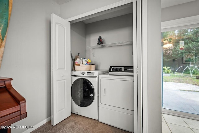 clothes washing area featuring independent washer and dryer and light colored carpet