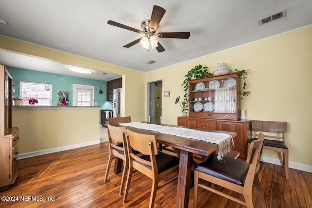 dining space featuring ceiling fan and dark hardwood / wood-style flooring