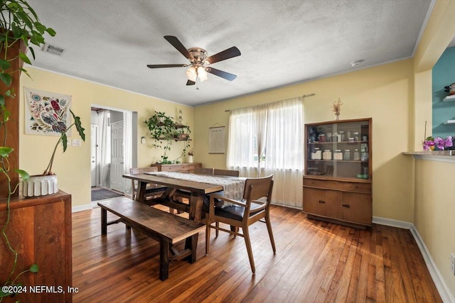 dining room featuring hardwood / wood-style floors, a textured ceiling, and ceiling fan