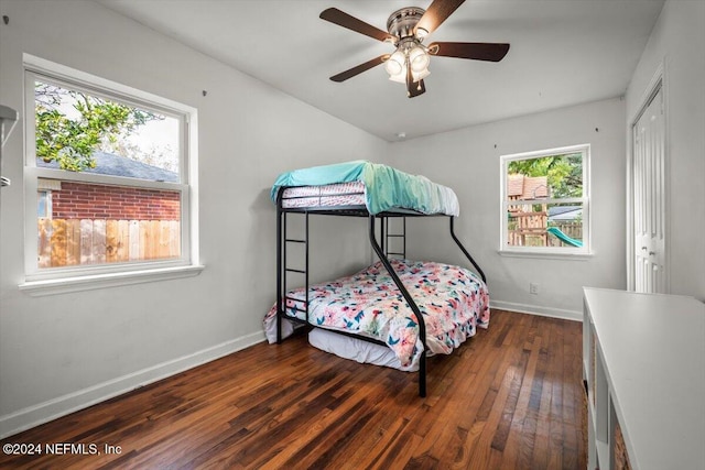 bedroom featuring ceiling fan, dark hardwood / wood-style flooring, and a closet