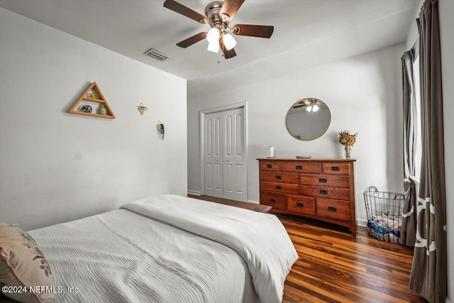 bedroom with ceiling fan, dark hardwood / wood-style flooring, and a closet