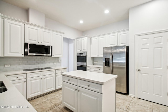 kitchen with light tile patterned floors, stainless steel appliances, and white cabinetry