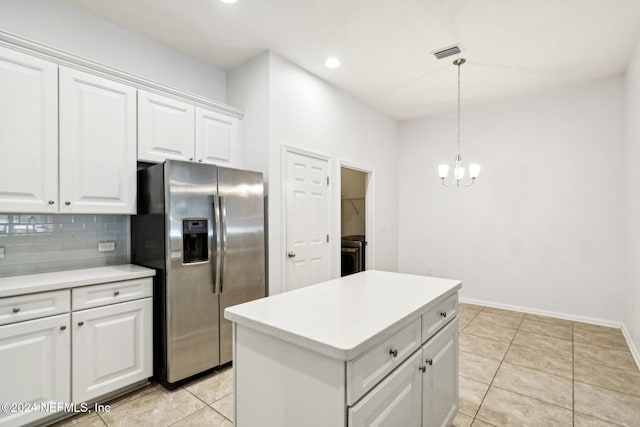 kitchen featuring white cabinets, stainless steel refrigerator with ice dispenser, decorative light fixtures, and light tile patterned flooring