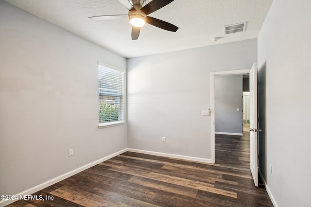 unfurnished room featuring a textured ceiling, dark hardwood / wood-style flooring, and ceiling fan