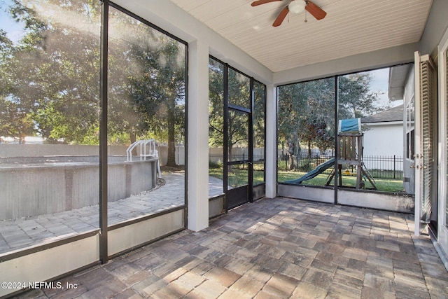 unfurnished sunroom featuring ceiling fan and wooden ceiling