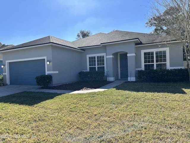 view of front of home featuring a garage and a front lawn