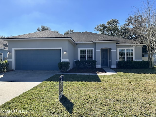 view of front of property featuring a front yard and a garage