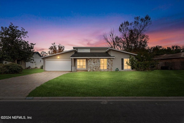 view of front of house with a yard and a garage