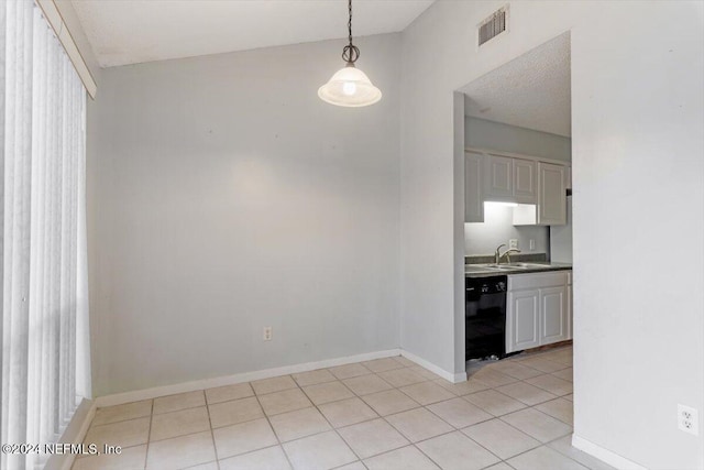 unfurnished dining area featuring light tile patterned floors and sink