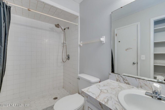 bathroom with vanity, toilet, and walk in shower