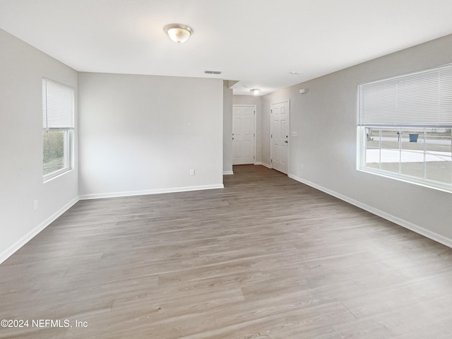 empty room with light hardwood / wood-style floors