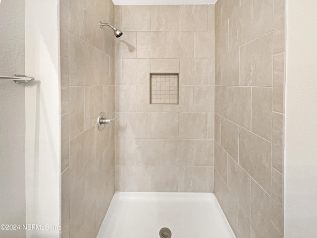 bathroom with a tile shower