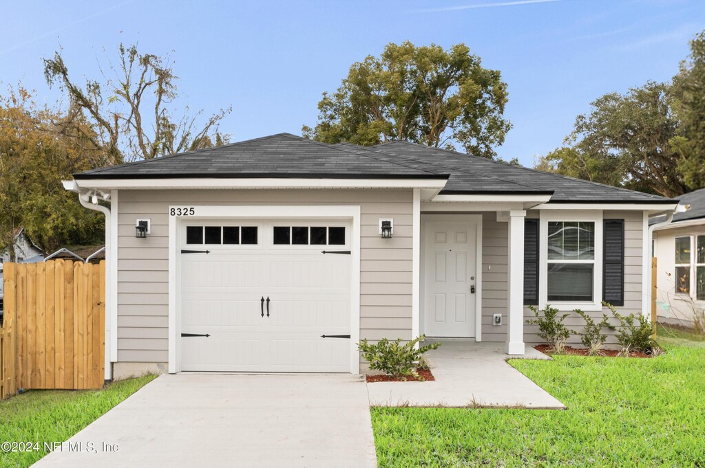 ranch-style home featuring a front yard and a garage