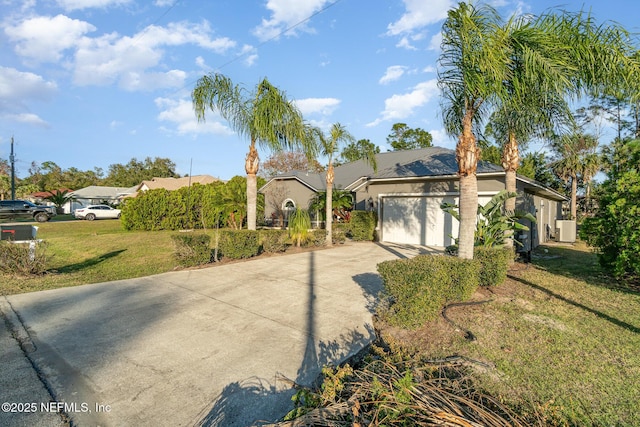 view of front facade with cooling unit, a garage, and a front lawn