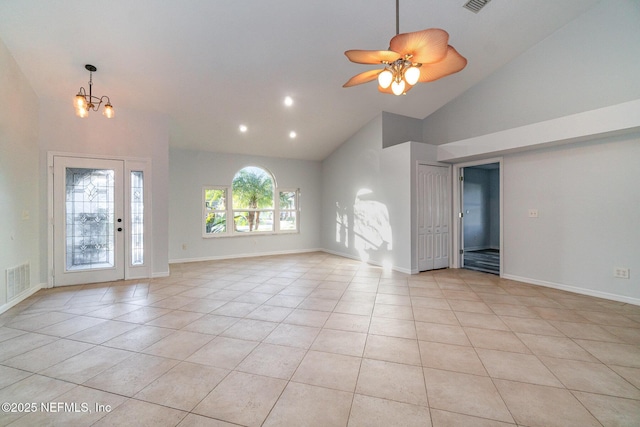 unfurnished living room featuring light tile patterned floors, ceiling fan with notable chandelier, and high vaulted ceiling