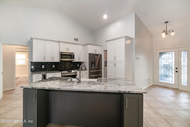 kitchen with a large island, stainless steel appliances, high vaulted ceiling, pendant lighting, and white cabinets