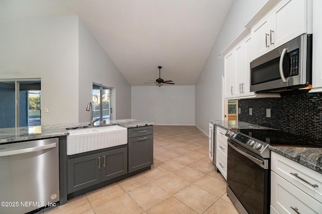 kitchen with ceiling fan, sink, stainless steel appliances, light tile patterned floors, and white cabinets