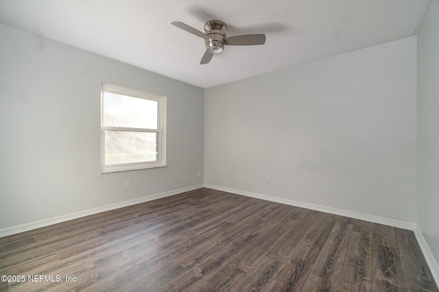 empty room featuring a textured ceiling, dark hardwood / wood-style floors, and ceiling fan