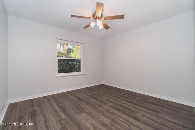 spare room with dark hardwood / wood-style flooring