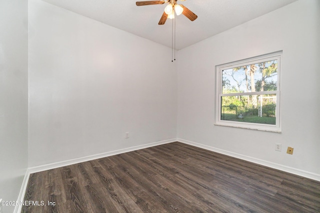 spare room featuring ceiling fan and dark wood-type flooring