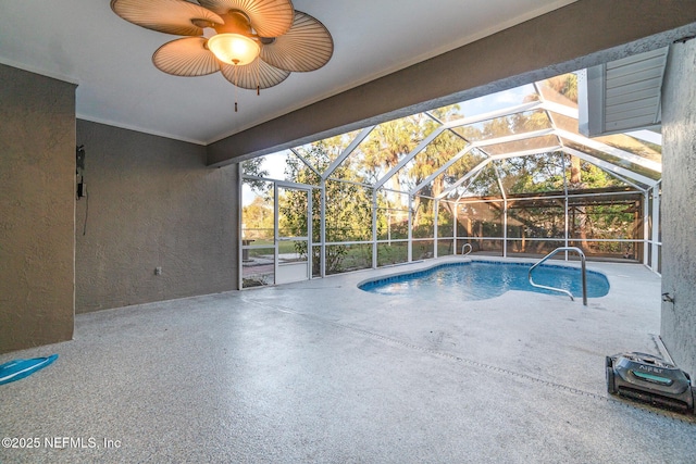 view of pool featuring a patio area, ceiling fan, and glass enclosure