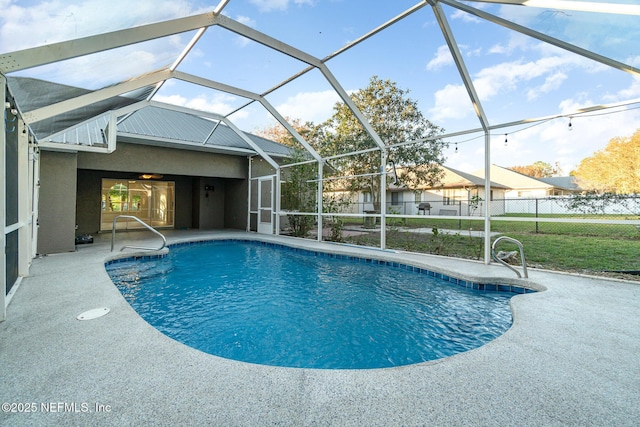 view of swimming pool featuring a lanai and a patio