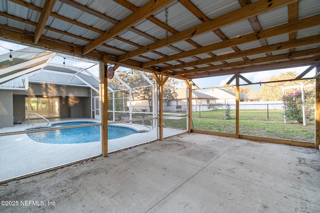 view of pool featuring glass enclosure, a yard, and a patio