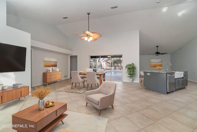 tiled living room featuring vaulted ceiling, ceiling fan, and sink