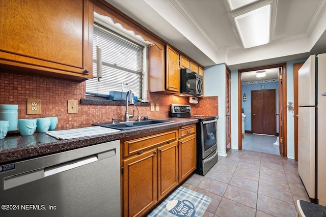 kitchen with backsplash, light tile patterned flooring, sink, and stainless steel appliances