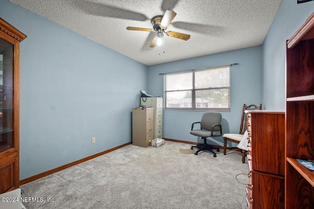 office area featuring ceiling fan, a textured ceiling, and light carpet