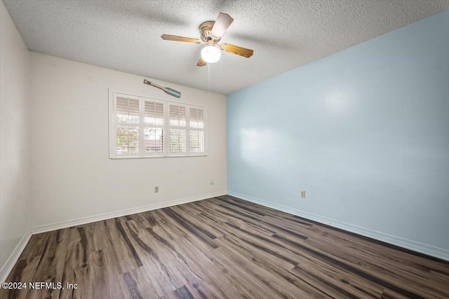 spare room featuring ceiling fan, wood-type flooring, and a textured ceiling