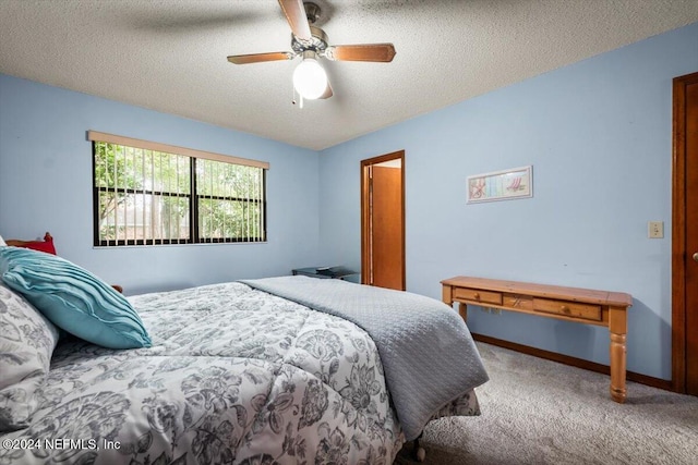 carpeted bedroom featuring a textured ceiling and ceiling fan