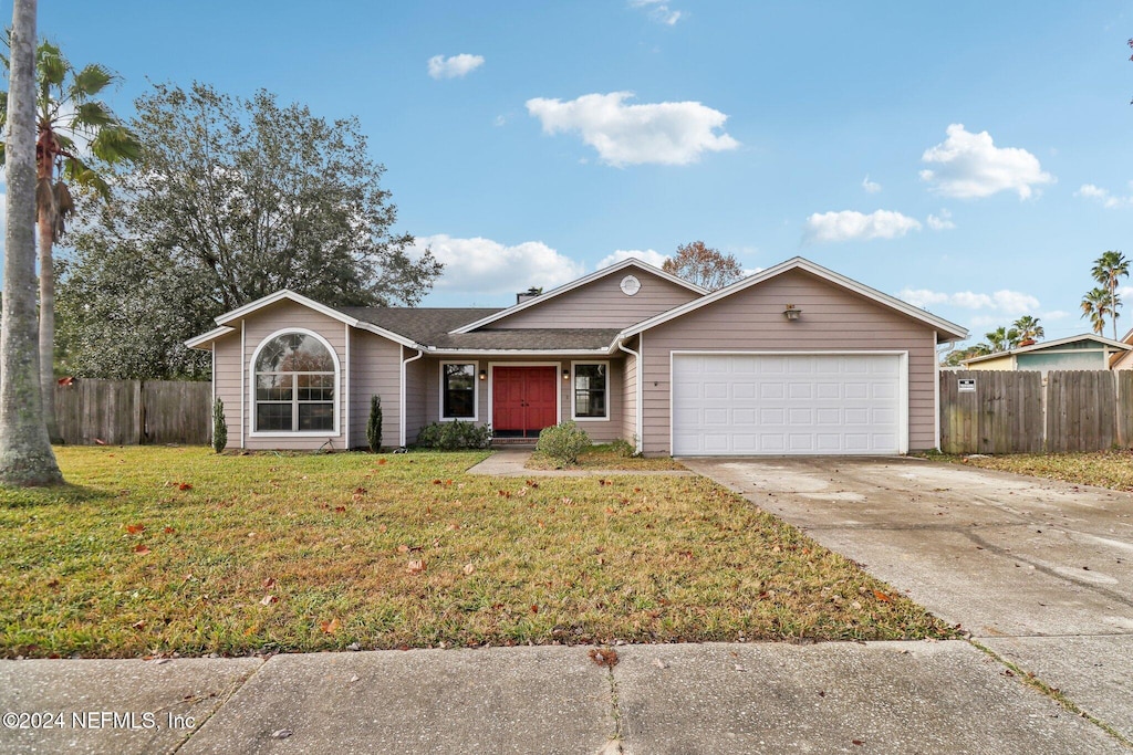 ranch-style house with a garage and a front yard