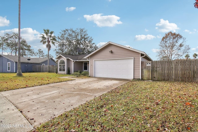 ranch-style house featuring a front yard and a garage