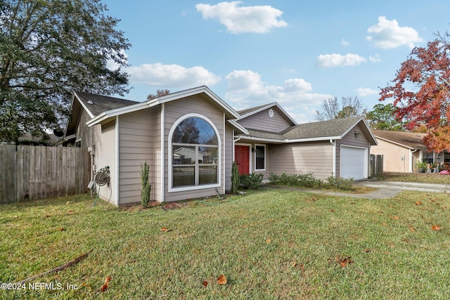 view of front of property featuring a garage and a front yard