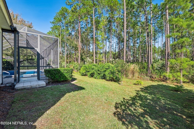 view of yard featuring a lanai and a swimming pool