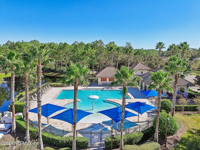 view of pool featuring a patio and a water view