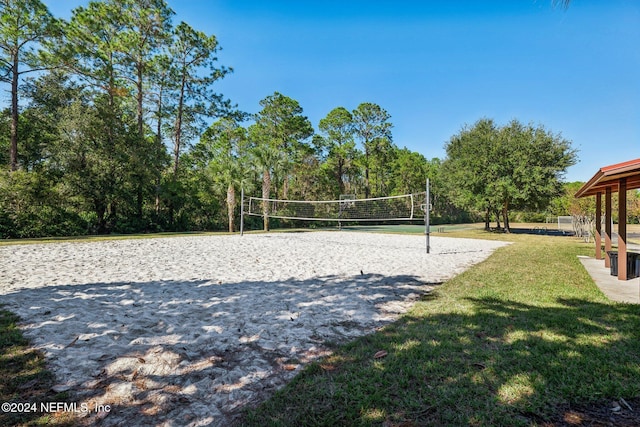 surrounding community featuring a yard and volleyball court