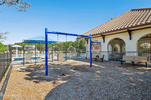 view of play area featuring a community pool