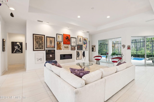 tiled living room with a tray ceiling