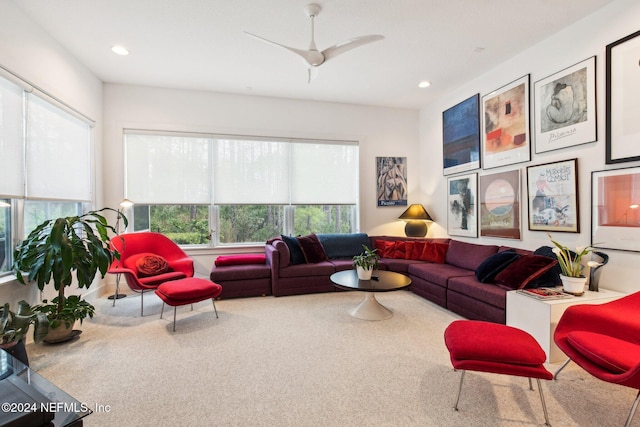 carpeted living room with ceiling fan