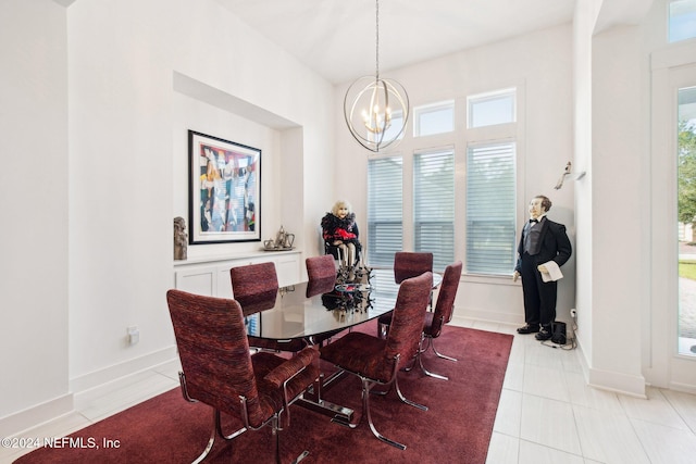 tiled dining room with an inviting chandelier