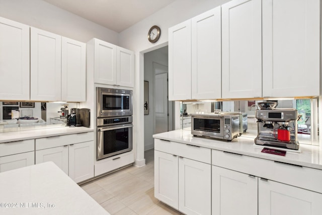 kitchen with stainless steel appliances and white cabinets